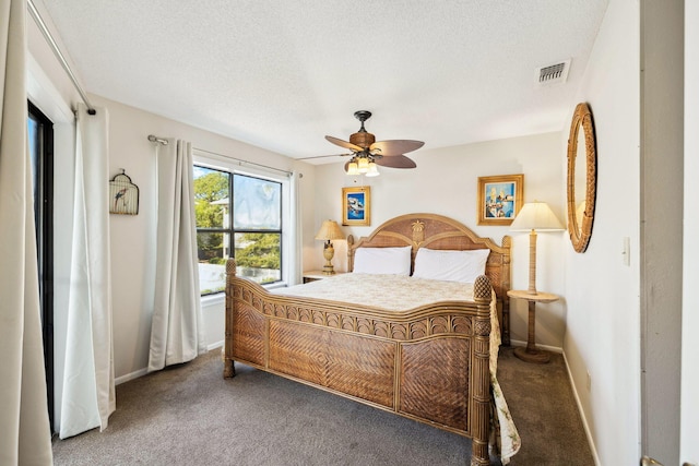 bedroom with visible vents, a ceiling fan, a textured ceiling, carpet floors, and baseboards