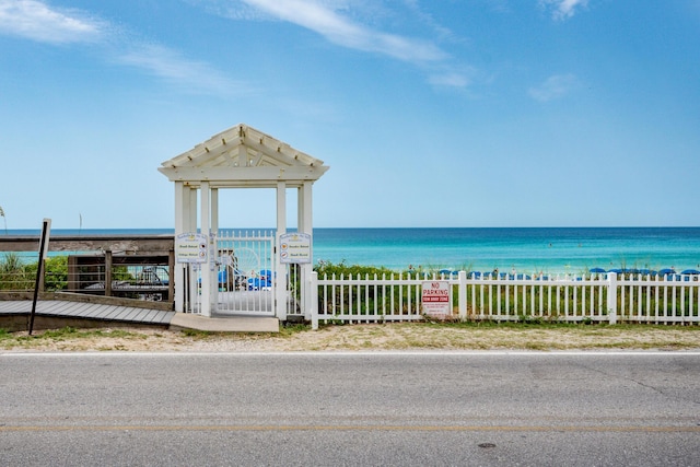 water view with a view of the beach and fence