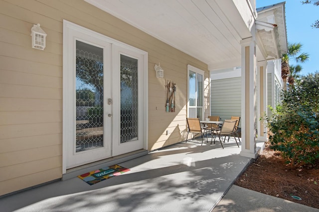 view of exterior entry with a porch