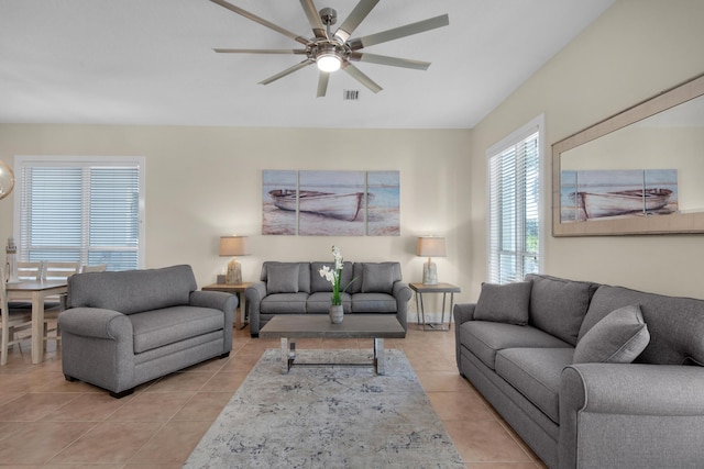 living area with light tile patterned floors, ceiling fan, and visible vents