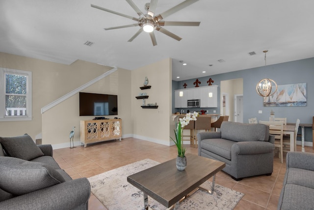 living room with light tile patterned floors, baseboards, and visible vents