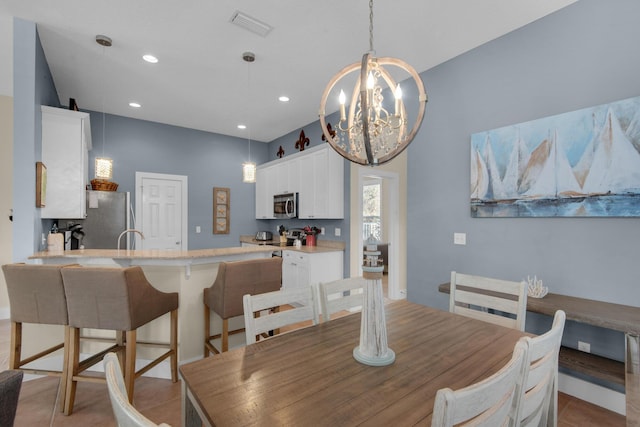 dining area featuring recessed lighting, visible vents, and a notable chandelier