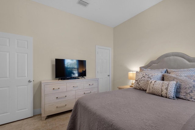 bedroom with visible vents and light tile patterned floors