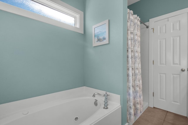 bathroom with a shower with curtain, a garden tub, and tile patterned floors