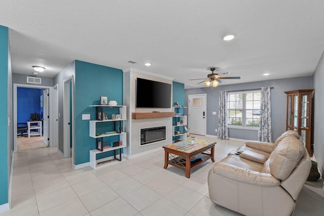 living room with a large fireplace, light tile patterned floors, baseboards, a ceiling fan, and recessed lighting