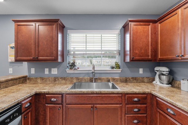 kitchen featuring light countertops, a sink, and dishwasher