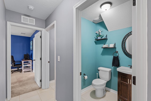 half bathroom featuring tile patterned flooring, visible vents, a textured ceiling, and toilet