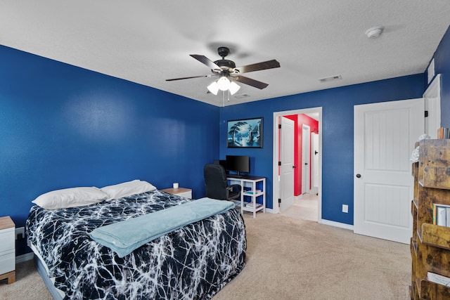 bedroom featuring a textured ceiling, ceiling fan, carpet floors, visible vents, and baseboards