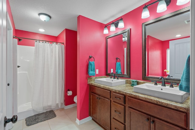 bathroom featuring toilet, tile patterned flooring, a sink, and a shower with shower curtain