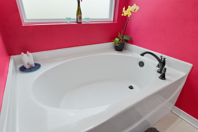 full bath featuring tile patterned flooring and a bath