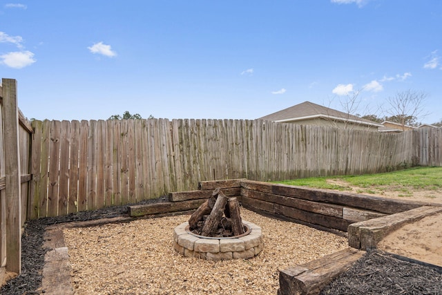 view of yard with an outdoor fire pit and a fenced backyard