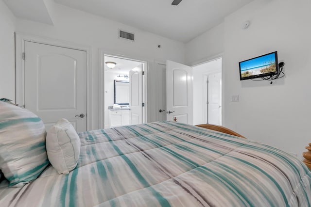 bedroom featuring ensuite bathroom, ceiling fan, and visible vents