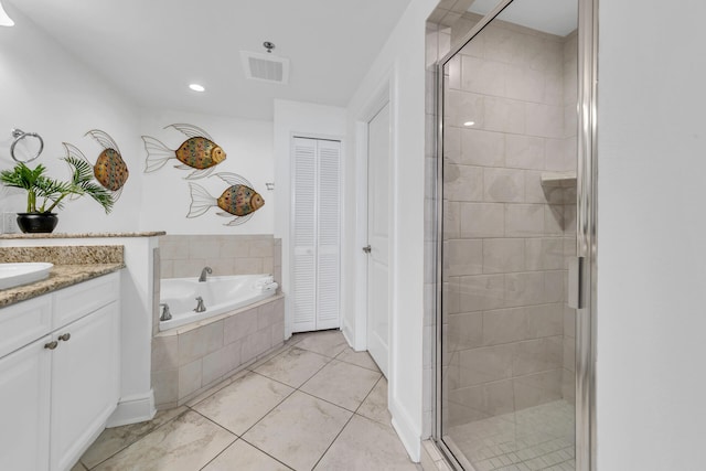 full bathroom featuring visible vents, a garden tub, vanity, and a shower stall