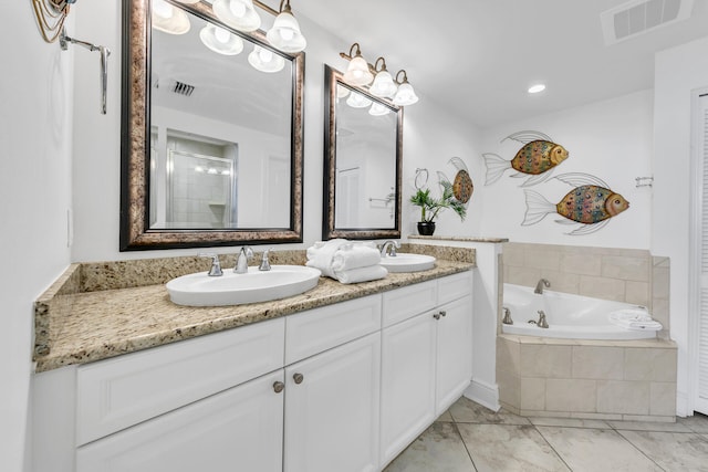 full bath featuring a bath, double vanity, a sink, and visible vents