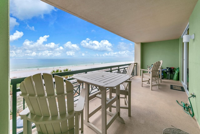 balcony with a water view and a beach view