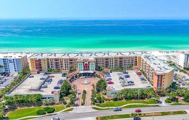 drone / aerial view featuring a water view and a view of the beach