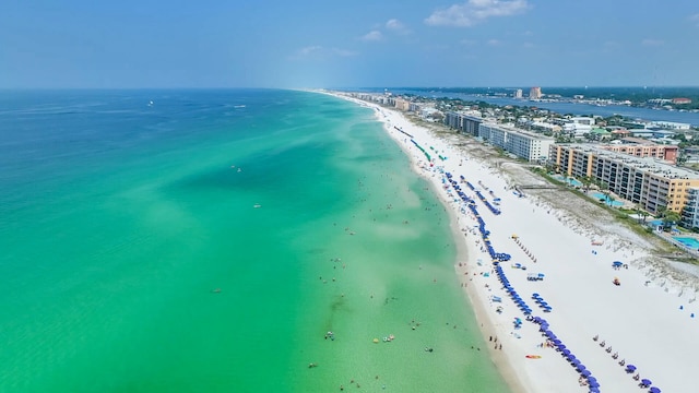 bird's eye view with a water view and a beach view