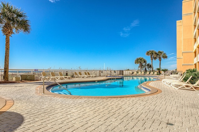 community pool featuring a patio area and fence