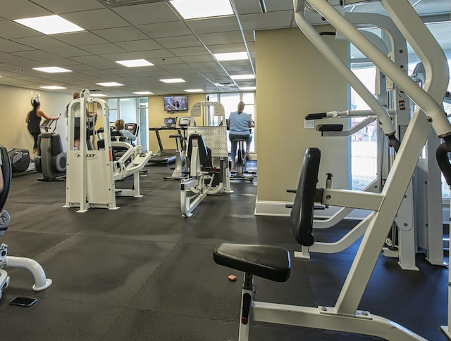 gym with a paneled ceiling