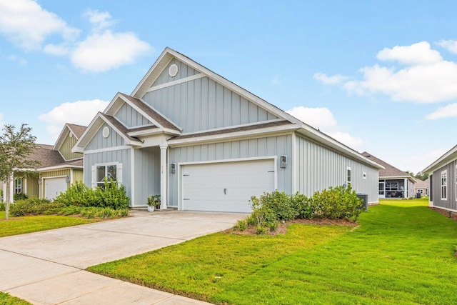 view of front of home featuring board and batten siding, a front yard, driveway, and an attached garage