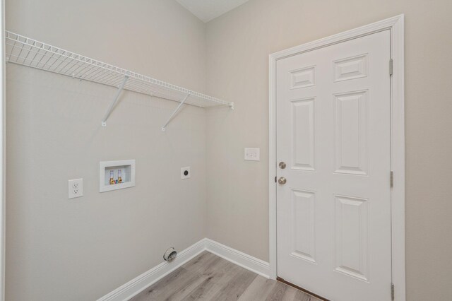 washroom with laundry area, light wood finished floors, baseboards, hookup for a washing machine, and electric dryer hookup