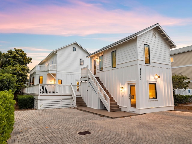 view of front of house with board and batten siding and stairs