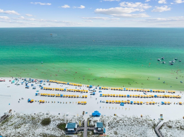 drone / aerial view featuring a view of the beach and a water view