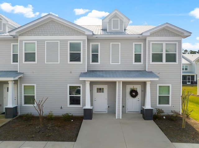 townhome / multi-family property featuring metal roof