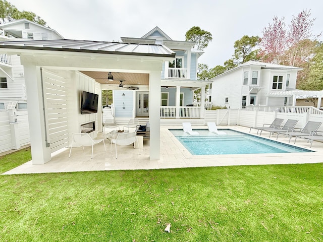 rear view of property featuring ceiling fan, fence, metal roof, a yard, and a standing seam roof