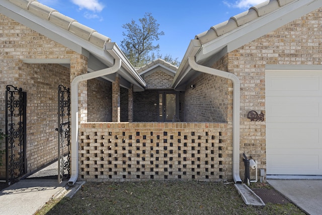 view of home's exterior featuring a garage and brick siding