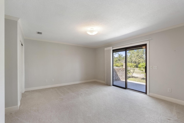 empty room featuring a textured ceiling, crown molding, visible vents, and light carpet