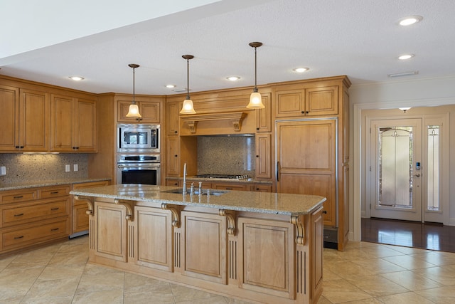 kitchen featuring light stone countertops, brown cabinets, built in appliances, and a sink