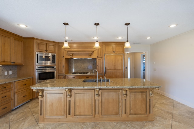 kitchen with decorative backsplash, light stone counters, stainless steel appliances, and a sink