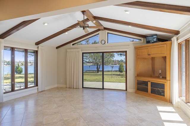 empty room with baseboards, vaulted ceiling with beams, and ceiling fan