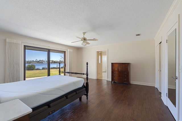 bedroom featuring visible vents, baseboards, wood finished floors, a textured ceiling, and a ceiling fan