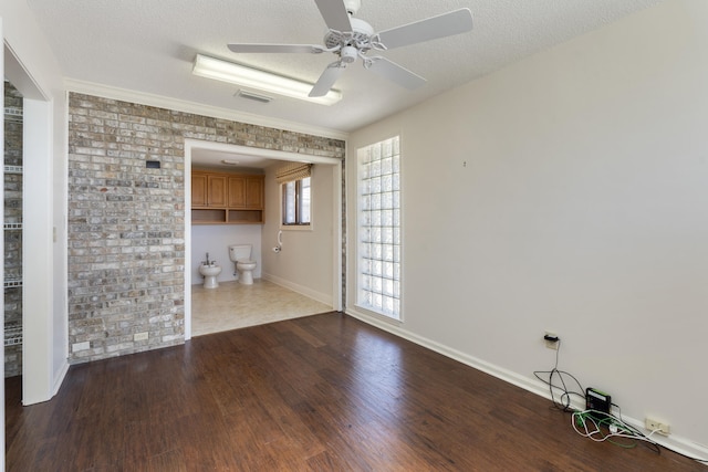 interior space featuring visible vents, a textured ceiling, dark wood-type flooring, and ceiling fan