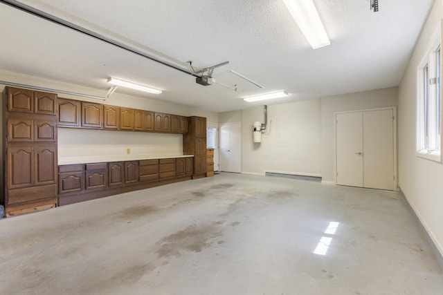 garage featuring baseboards and a garage door opener