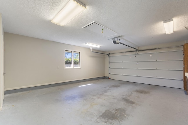 garage featuring a garage door opener and baseboards