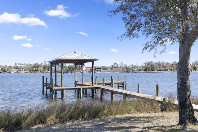 dock area with a water view and boat lift