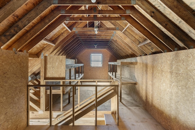 unfinished attic featuring an upstairs landing