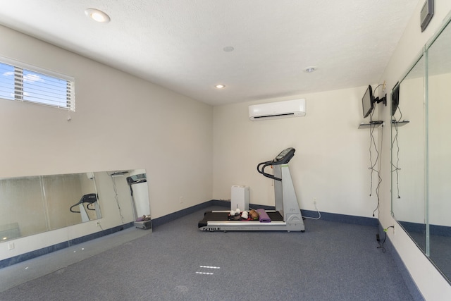 exercise room featuring recessed lighting, a wall mounted AC, and baseboards