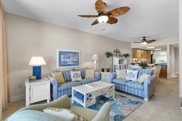 living room featuring a textured ceiling, baseboards, and light tile patterned floors