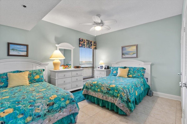 bedroom featuring a textured ceiling, ceiling fan, light tile patterned flooring, and baseboards