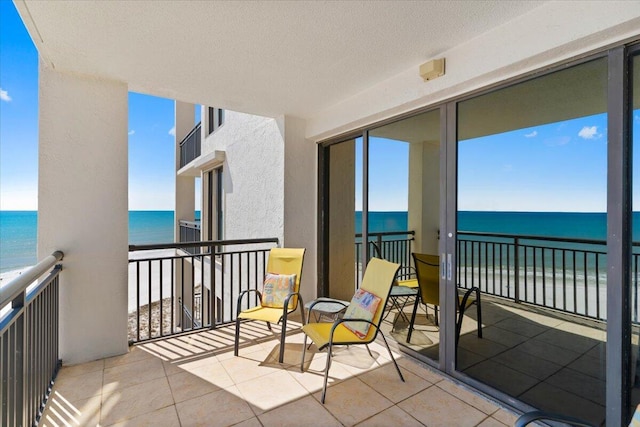 balcony with a view of the beach and a water view