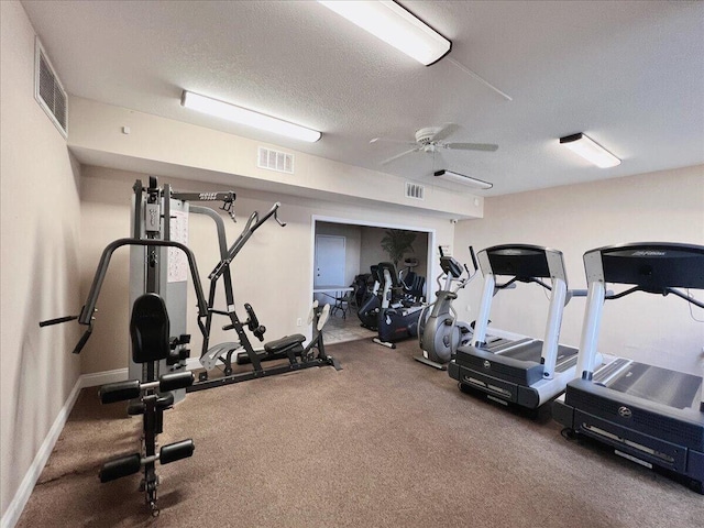 exercise area with ceiling fan, visible vents, and a textured ceiling