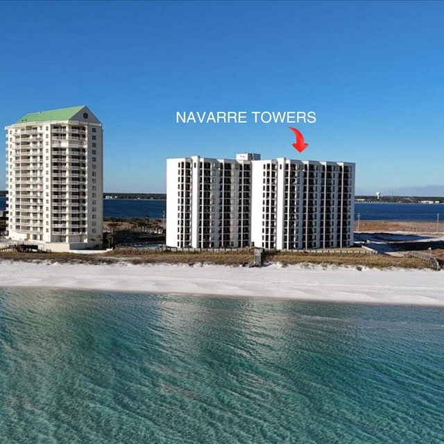 drone / aerial view with a water view and a view of the beach