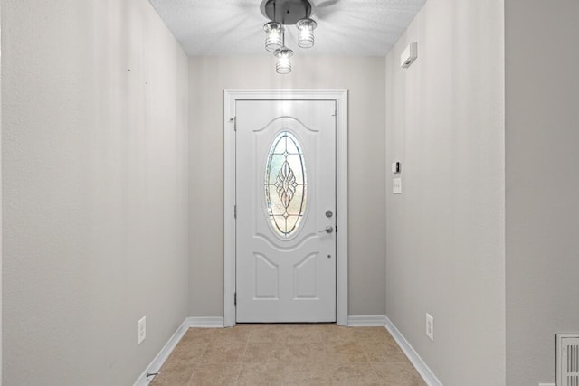 foyer entrance featuring baseboards