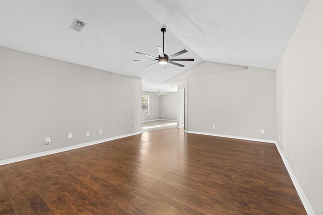 unfurnished living room with baseboards, visible vents, ceiling fan, wood finished floors, and vaulted ceiling