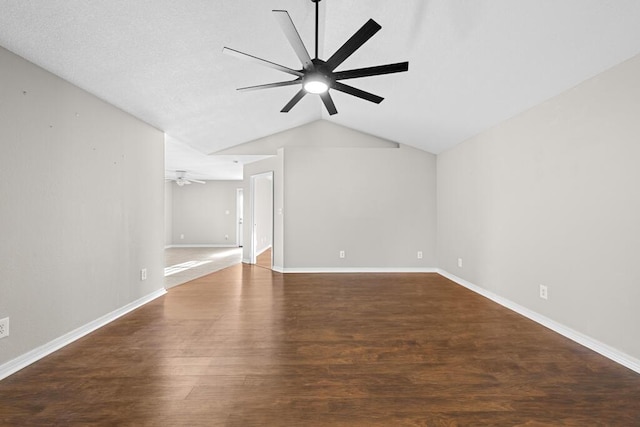 spare room featuring lofted ceiling, ceiling fan, baseboards, and wood finished floors