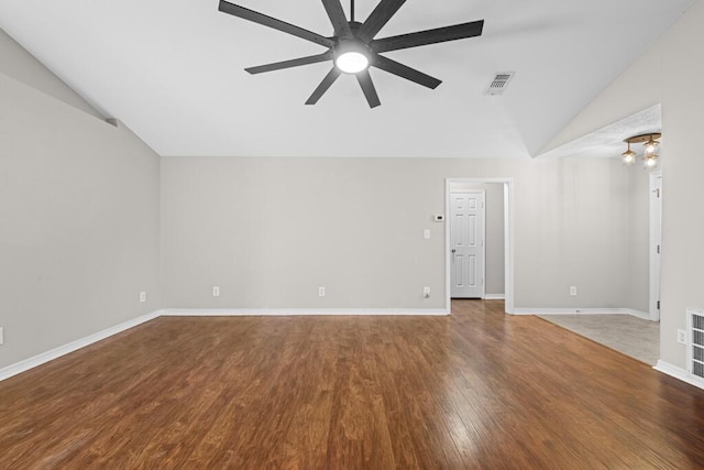 empty room with visible vents, vaulted ceiling, wood finished floors, baseboards, and ceiling fan with notable chandelier